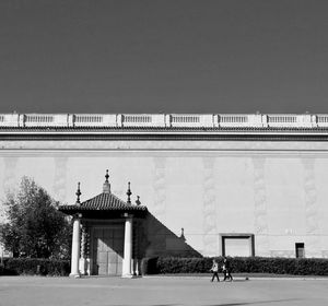 Man against built structure against clear sky