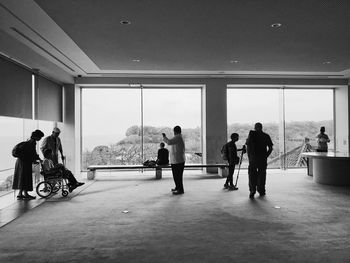 People standing by window in bus