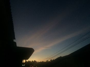 Low angle view of silhouette trees against sky