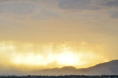 Scenic view of silhouette mountains against sky during sunset