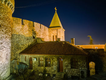 Exterior of illuminated building against sky at night