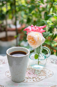 Close-up of rose in glass on table