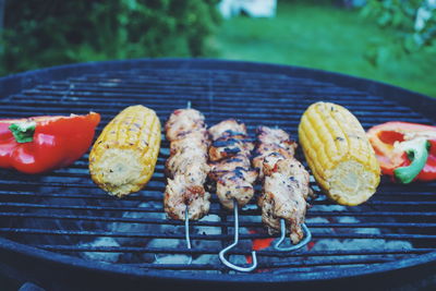 Close-up of food grilling on barbecue in back yard
