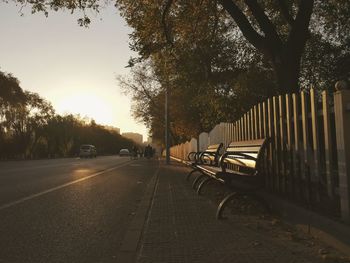 Cars on street in city against sky