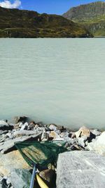 Scenic view of lake by rocky mountains