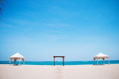 Scenic view of beach against blue sky