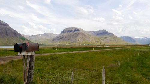 Scenic view of landscape with mailbox to stay connected in solitude