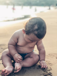 Boy sitting on beach