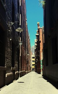 Walkway amidst buildings in city