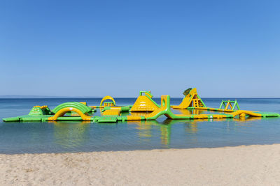 View of inflatable floating water park in the sea. fun aqua park for with attractions in the sea
