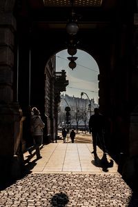 Rear view of people walking on street