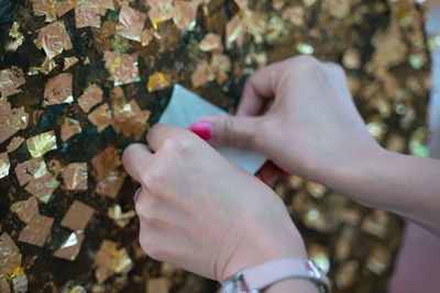 High angle view of hand holding paper