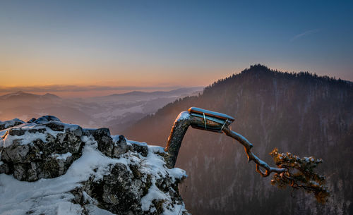 Scenic view of snowcapped mountains against sky during sunset