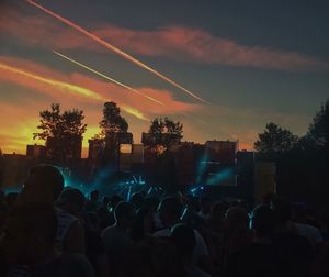 Crowd at event against sky during sunset