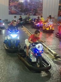 People riding motorcycle on street in city