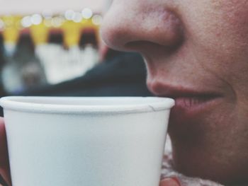 Close-up of woman with coffee cup