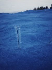 Close-up of frozen landscape against sky