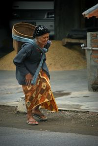 Woman walking on street in city