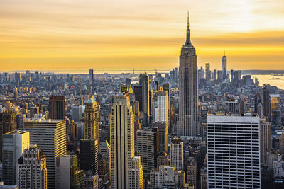 Aerial view of buildings in city during sunset