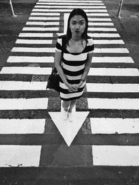 High angle view of woman on zebra crossing