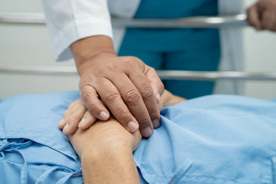 Holding hands asian senior or elderly old lady woman patient with love, care, encourage and empathy 