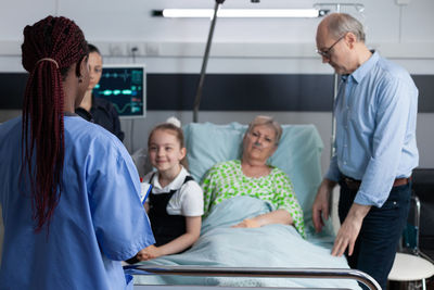 Rear view of business people working at clinic