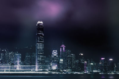 Illuminated buildings against sky at night