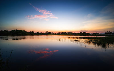 Scenic view of lake at sunset