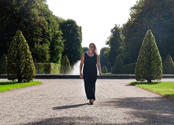 Portrait of woman walking at park