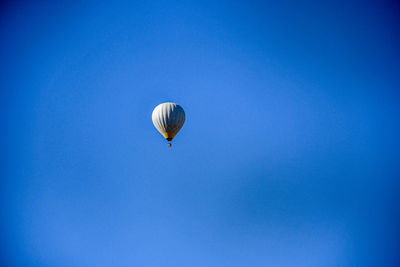 Low angle view of hot air balloon against blue sky