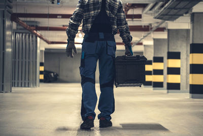 Low section of man walking on the road