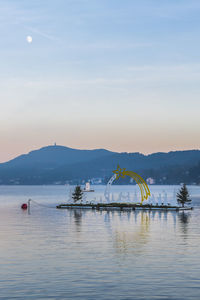 Last lights of the sunset in velden. reflections on the water and christmas atmosphere. austria.