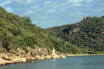 Scenic view of sea and mountains against sky