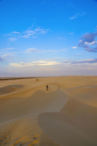 Scenic view of desert against blue sky