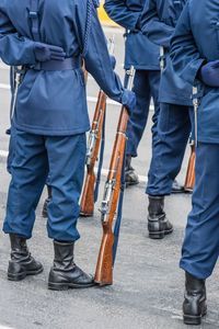 Low section of people standing on street