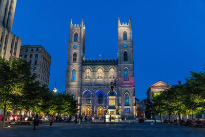 View of illuminated buildings against blue sky