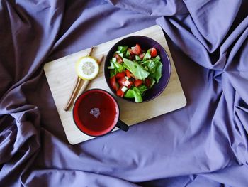 Directly above shot of breakfast served on purple bed