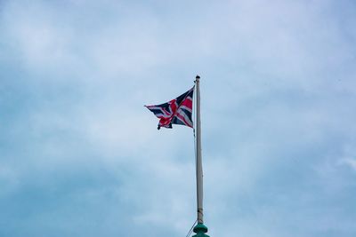 Low angle view of flag flags against sky