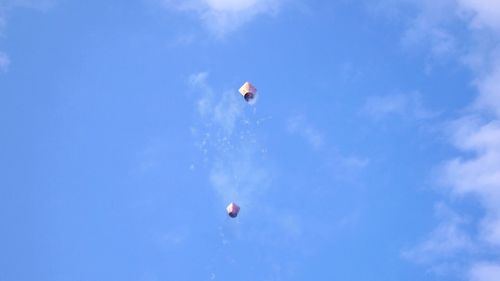 Low angle view of flying against blue sky