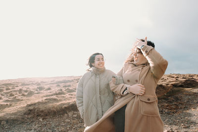 Rear view of woman standing against mountain