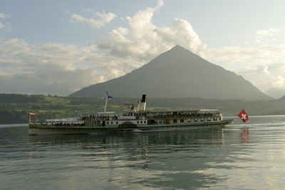 Scenic view of sea and mountains against sky