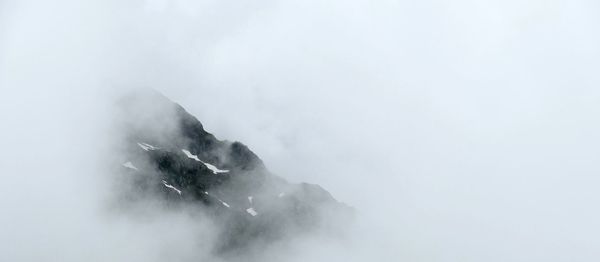 Scenic view of mountains against sky during winter