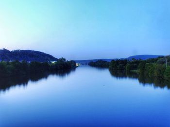 Scenic view of lake against clear blue sky