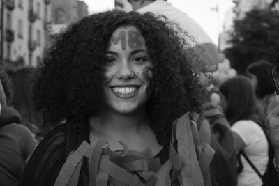 Close-up portrait of a smiling young woman in city