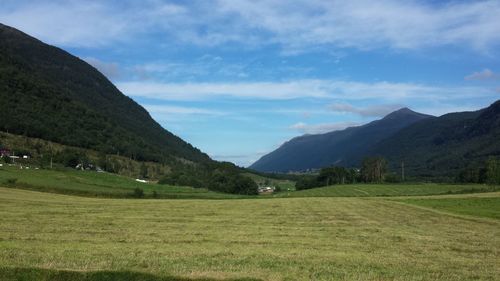 Scenic view of mountains against cloudy sky