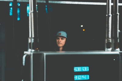 Man wearing cap in darkroom