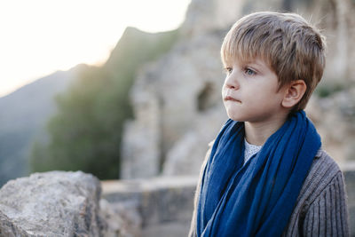 Close-up of boy looking away outdoors