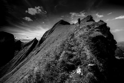 Low angle view of man hiking against sky