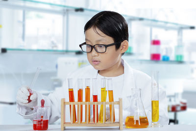 Boy doing experiment in laboratory