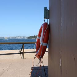Clothes hanging on rope at beach against clear sky